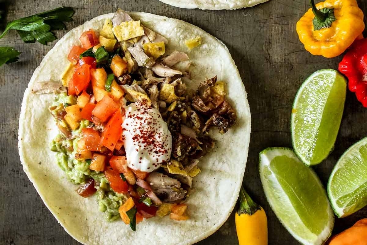 Taco night - Enjoy delicious tacos with a delectable combination of meat and vegetables, served on a rustic wooden table.