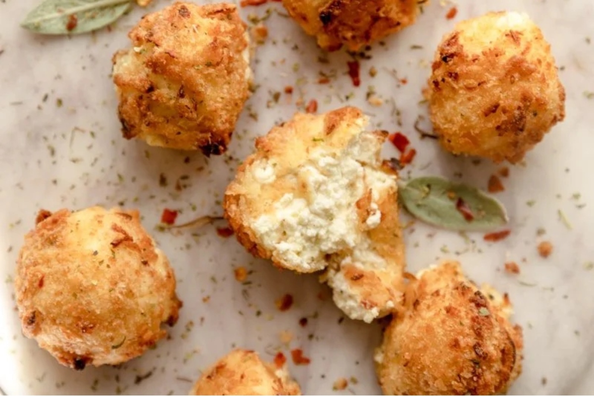Goat cheese garlic bread bites served on a white plate.