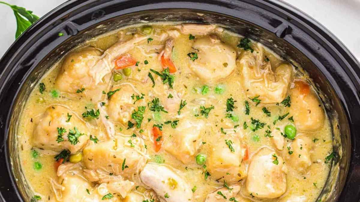 Crockpot chicken with parsley on top.
