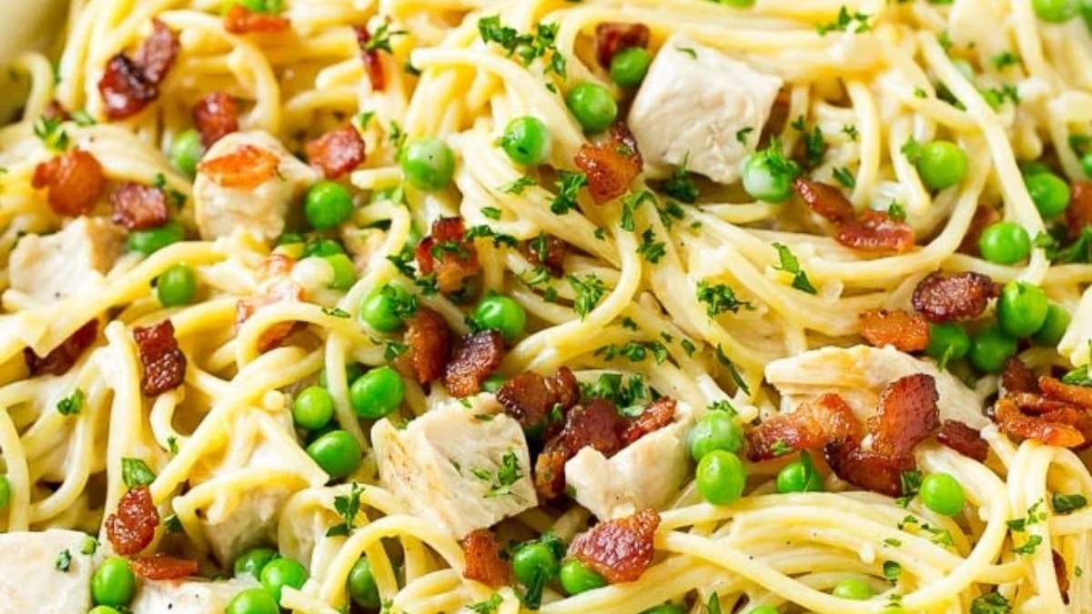 Chicken and pea pasta is a comforting and shared round-up of flavors, featuring the addition of crispy bacon and sweet peas.