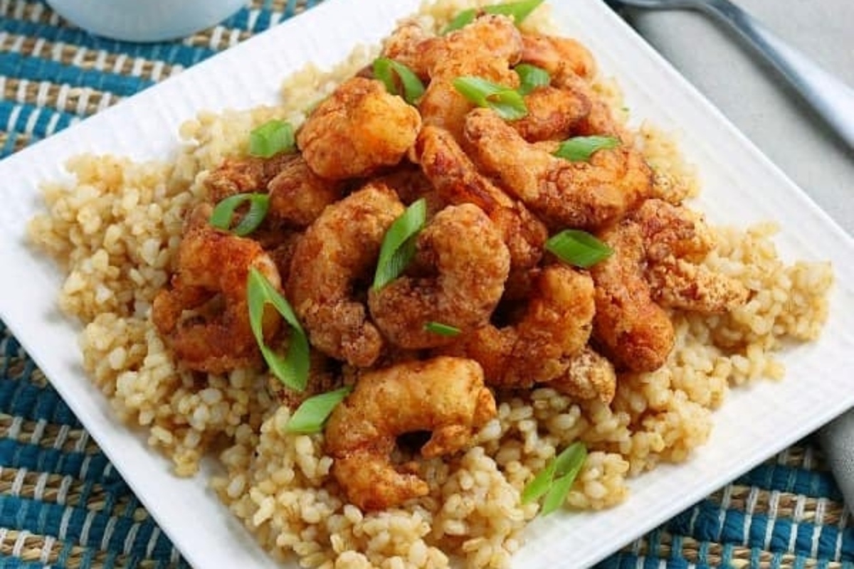 Shrimp dinners with fried shrimp and brown rice on a plate.