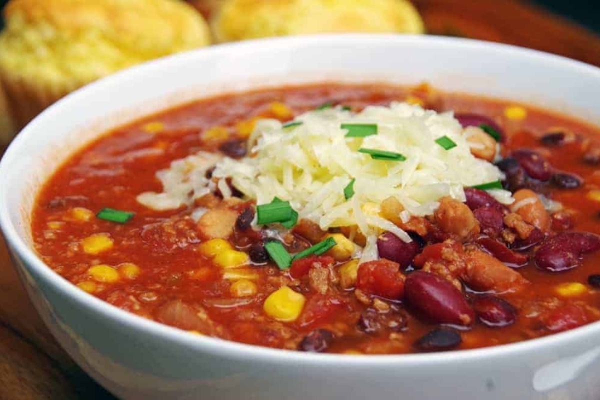 A slow cooker chili recipe with corn, beans and cornbread muffins.