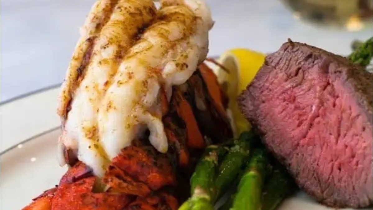 A romantic Valentine's Day dinner featuring a succulent steak paired with lobster and accompanied by asparagus. This exquisite main dish is sure to impress your loved one.
