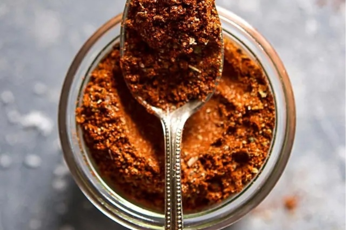 A jar filled with a spicy chili powder blend that makes for a unique and flavorful gift.