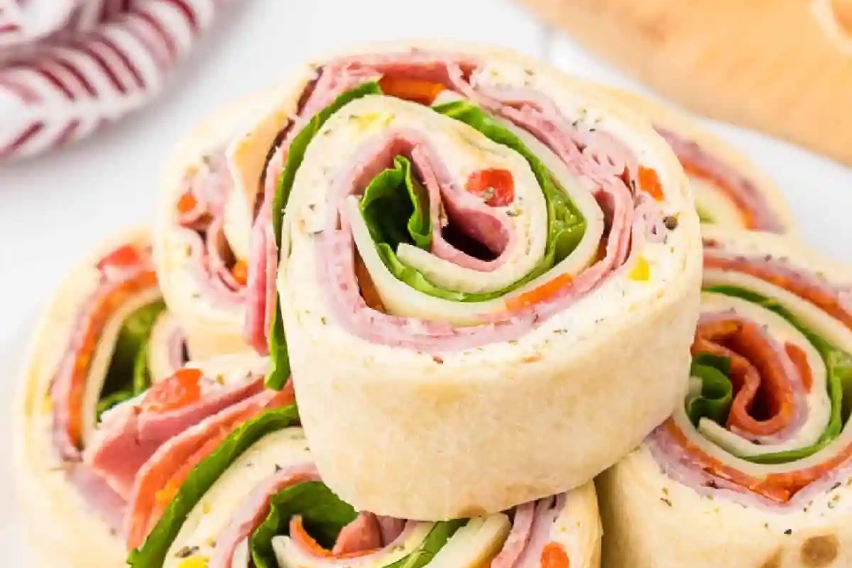Ham and spinach bite-sized wraps on a plate.