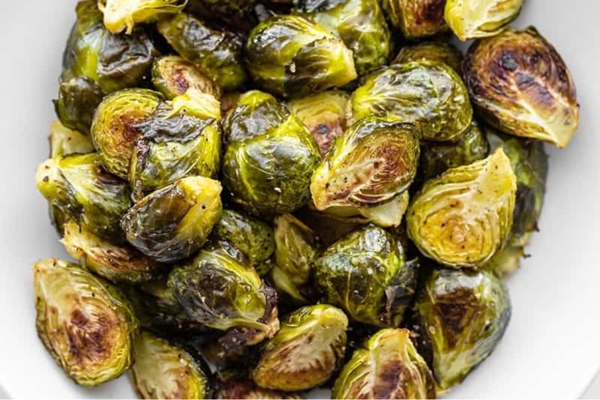 Christmas side dish - Roasted brussels sprouts in a white bowl.
