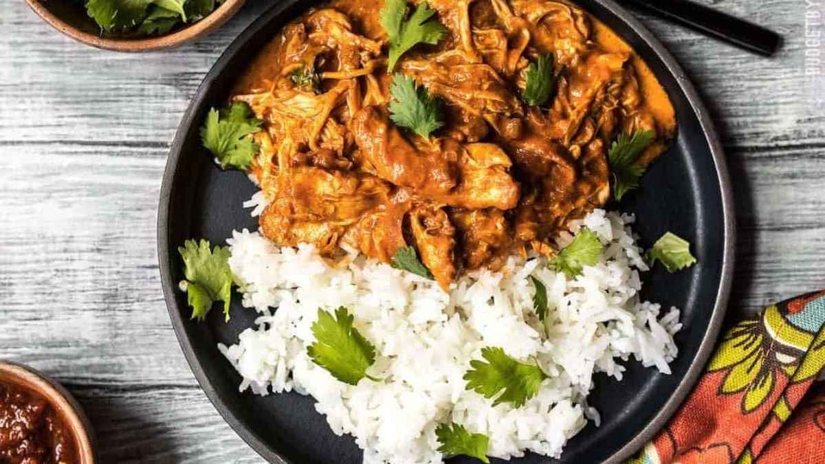 Slow cooker chicken tikka masala on a plate with rice.