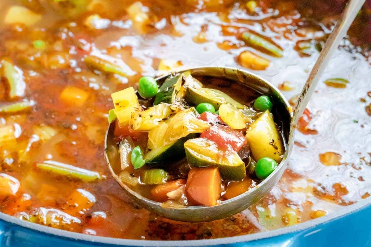 A flavorful spoonful of vegetable soup packed with a variety of vegetables and peas, following our satisfying vegetable soup recipe.