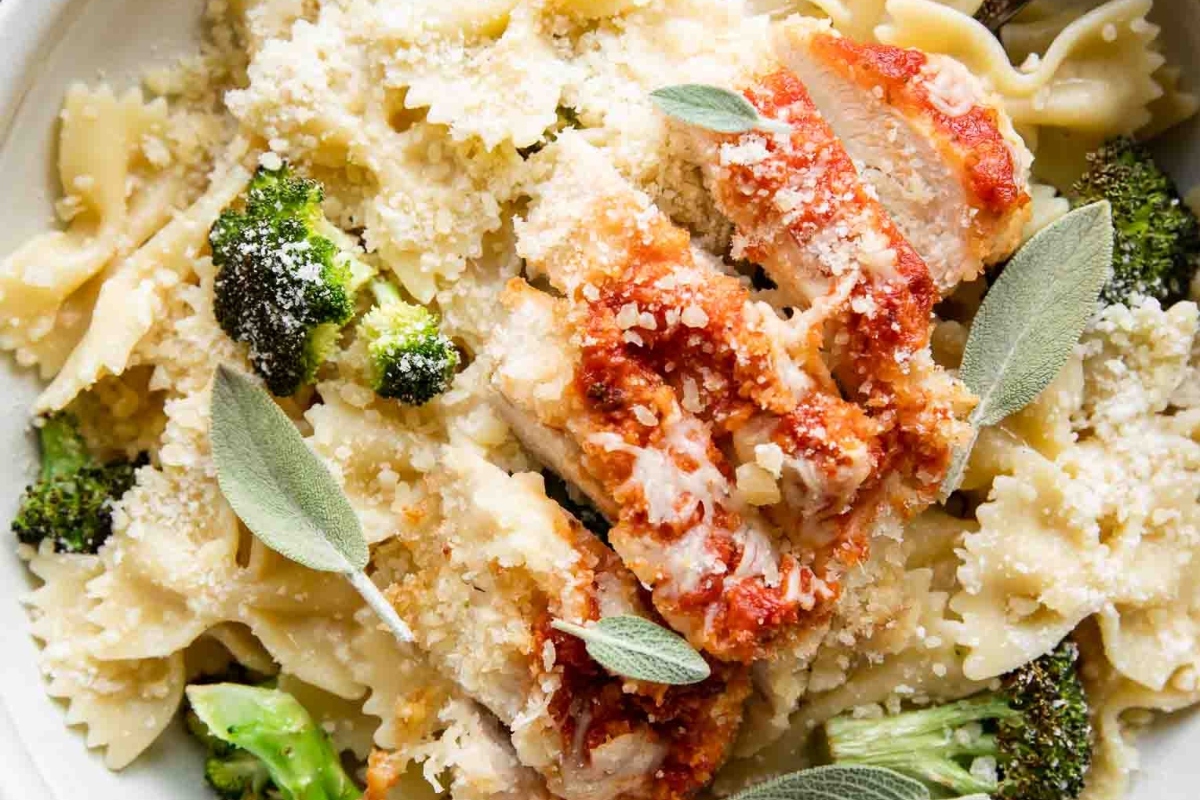 Make Ahead Pasta Dish: A bowl of pasta with chicken, broccoli and sage sprigs that can be prepared in advance.