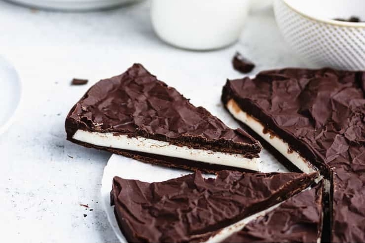 A decadent slice of peppermint chocolate ice cream pie on a plate.
