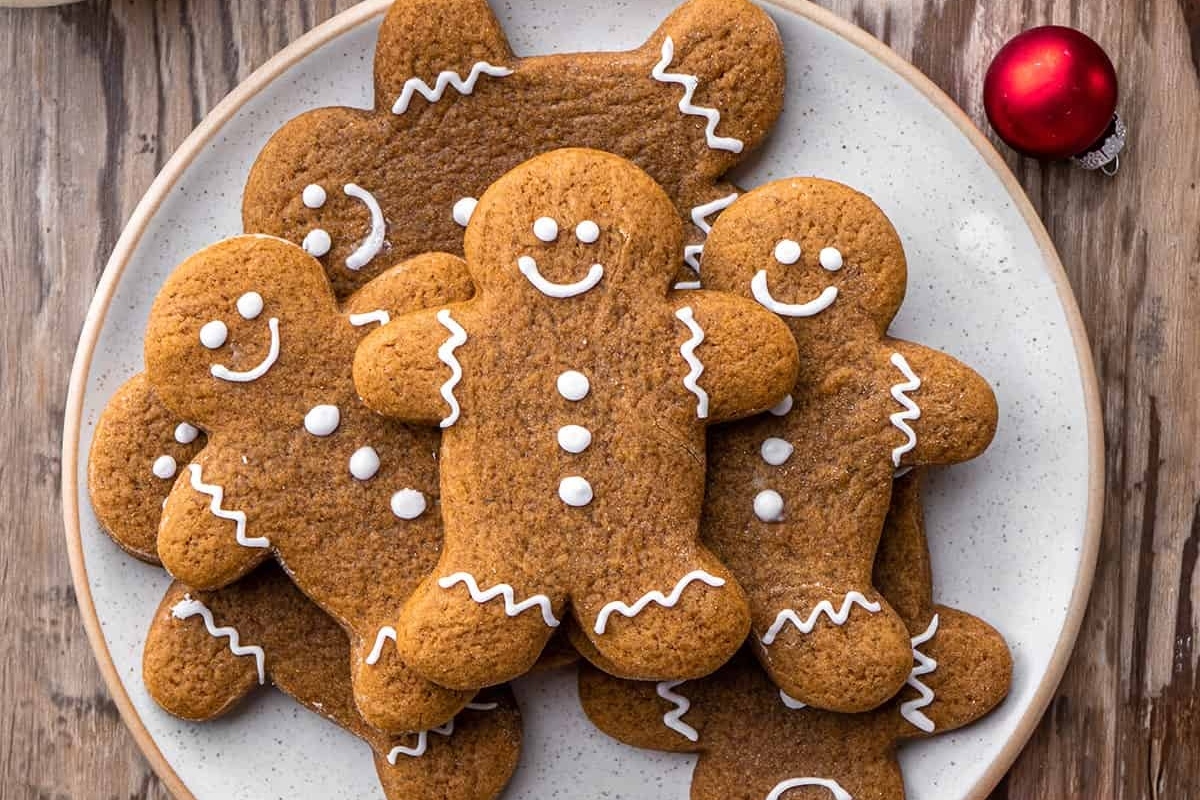 Christmas gingerbread cookies on a plate with festive decorations.