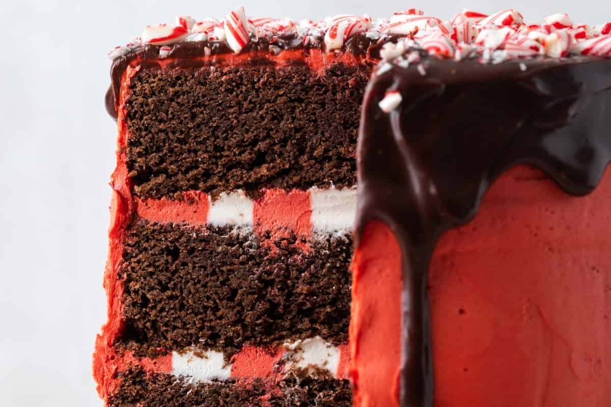 A peppermint cake recipe featuring a slice of red and white cake with delicious peppermint frosting.