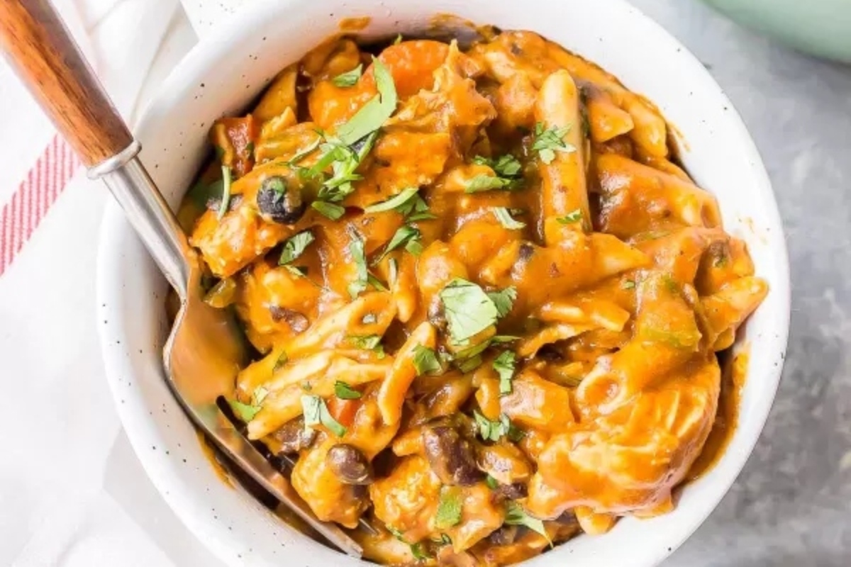 A delicious make-ahead pasta dish, served in a white bowl with a spoon.