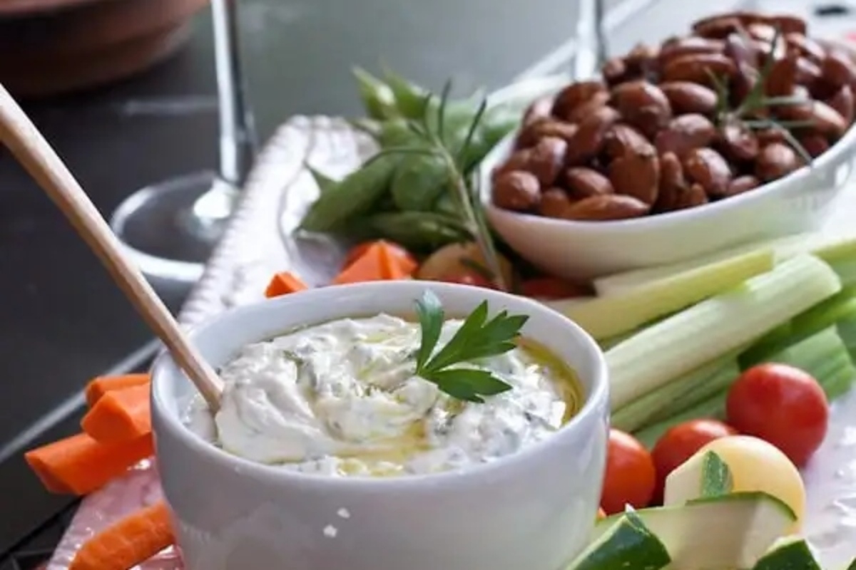A plate of appetizers with a wooden spoon.