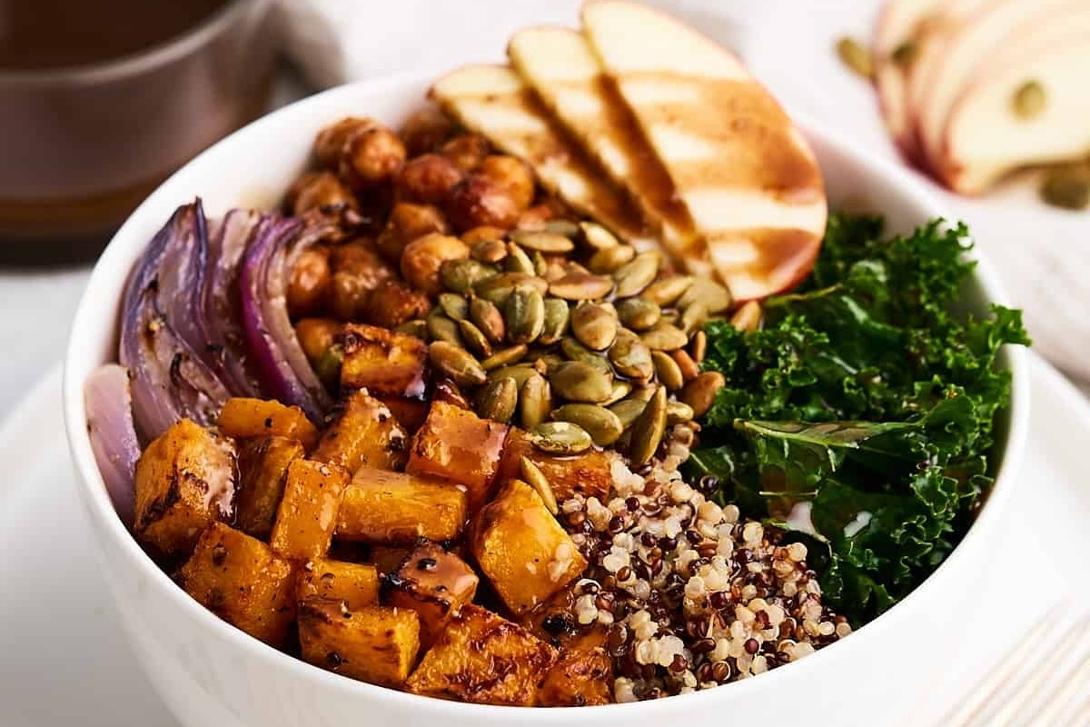 A hearty salad bowl with kale, quinoa, and apples.