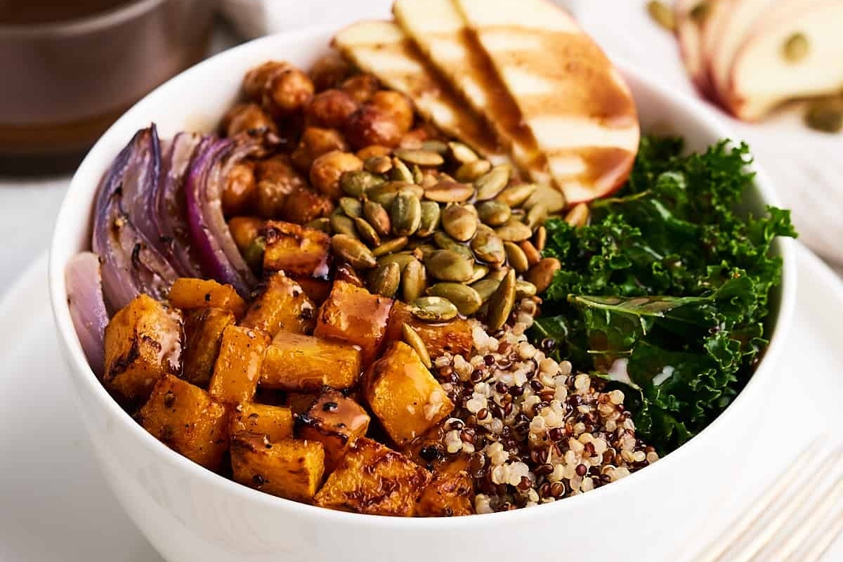A grain bowl with kale, apples, and quinoa.