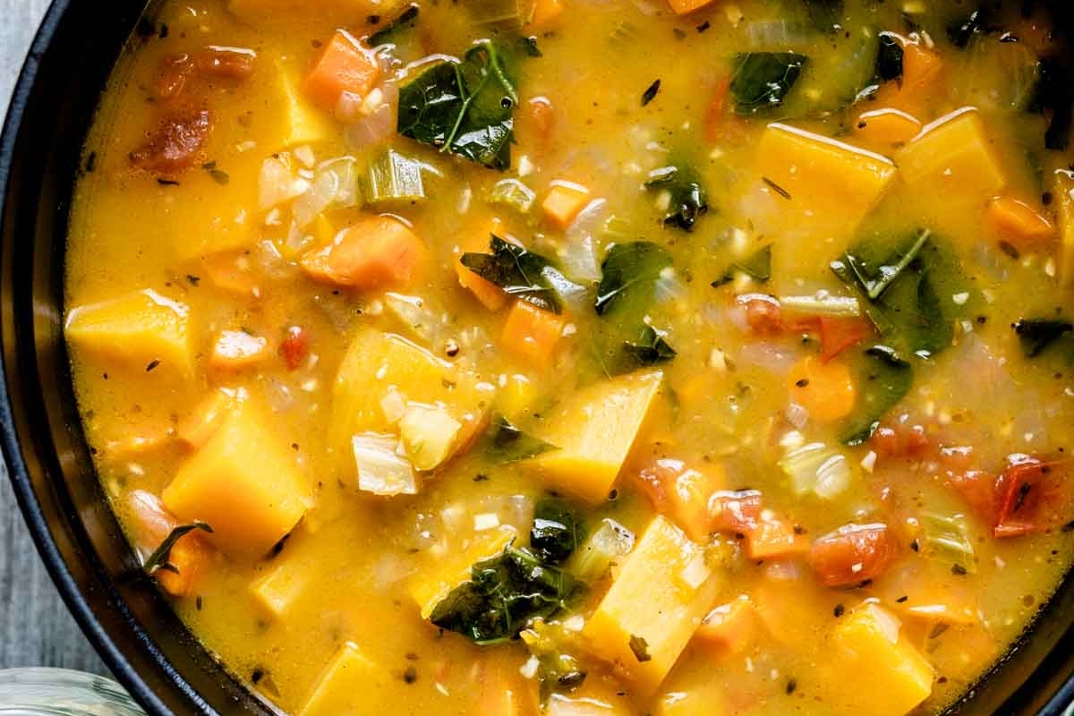 Vegetable soup with carrots, potatoes, and kale.