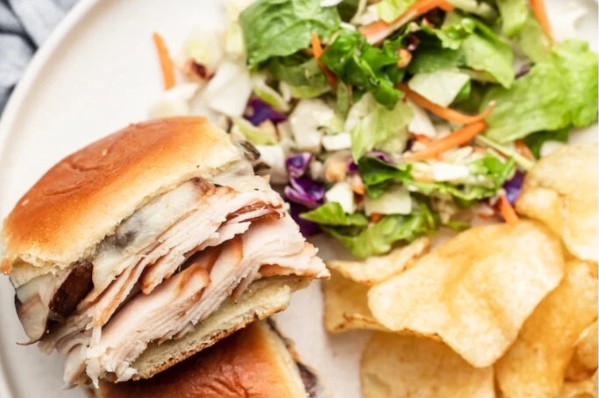 Easiest Turkey sliders recipe for Game Day served on a plate with chips and salad.