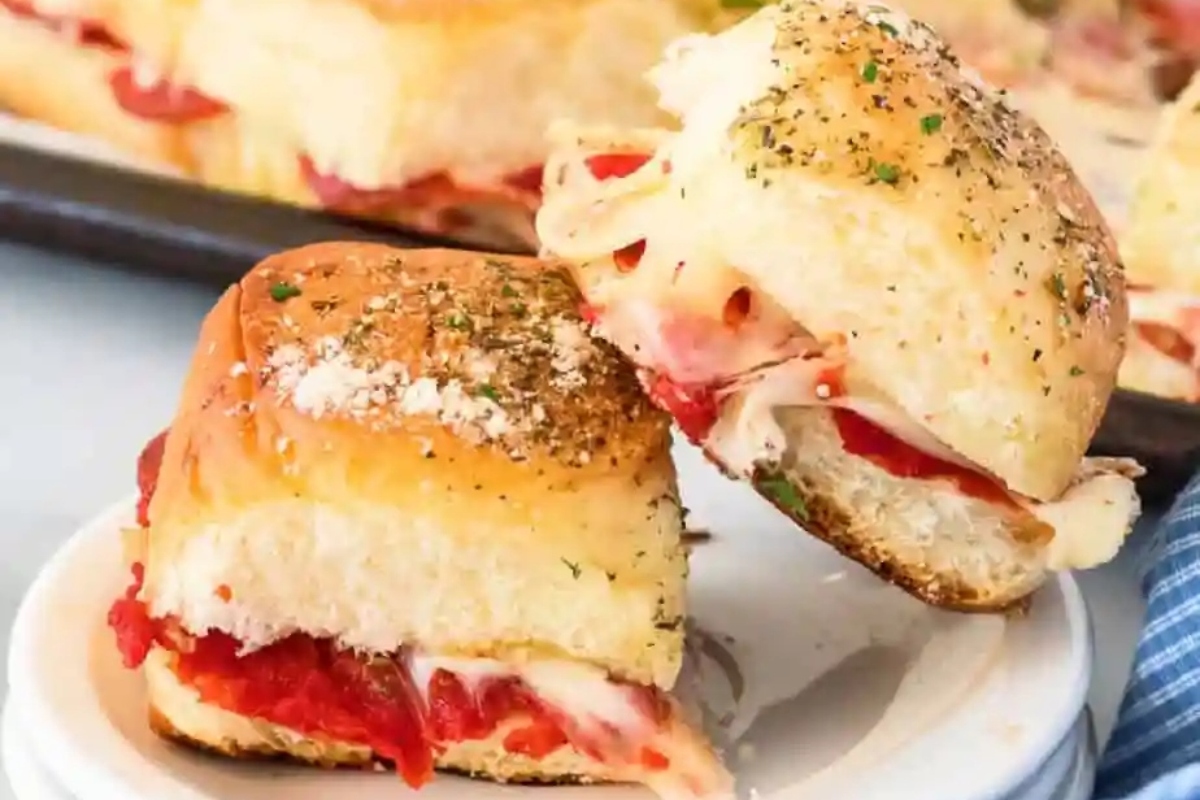 Bite-sized ham and pepperoni sliders on a plate, perfect for game day!