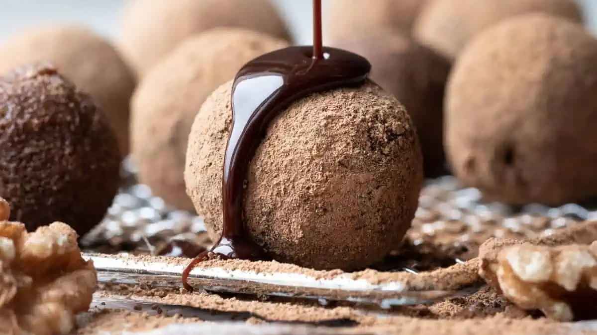 Healthy Bliss Balls with syrup on top.