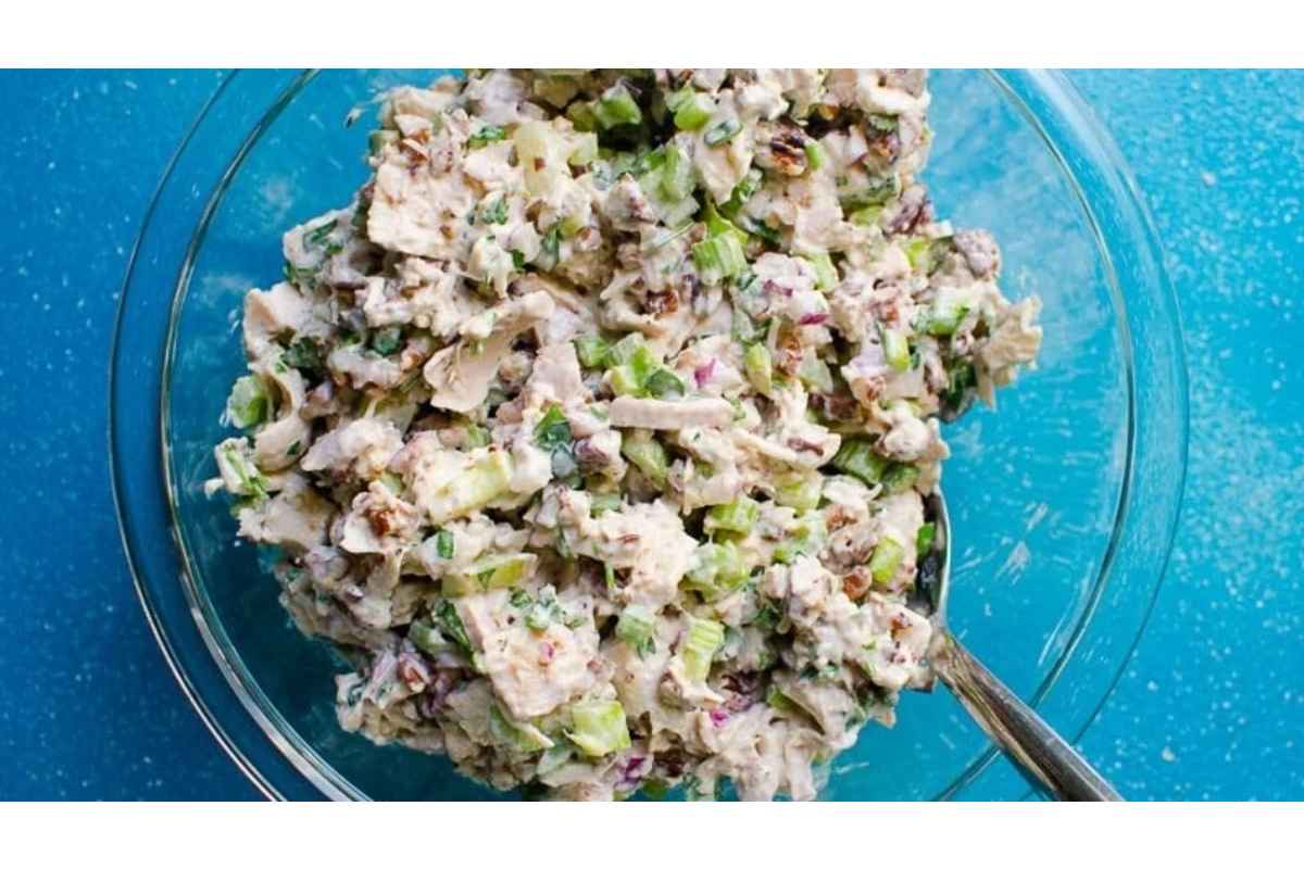 A high protein chicken salad on a blue background.