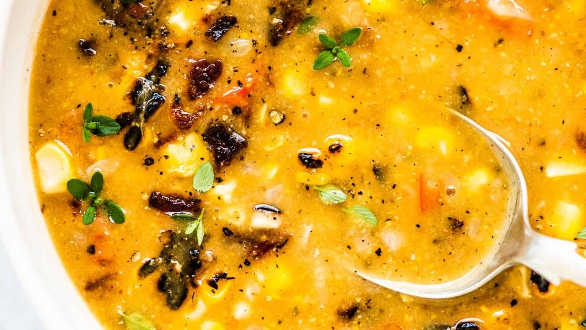 A delicious chowder recipe with a spoon in it.