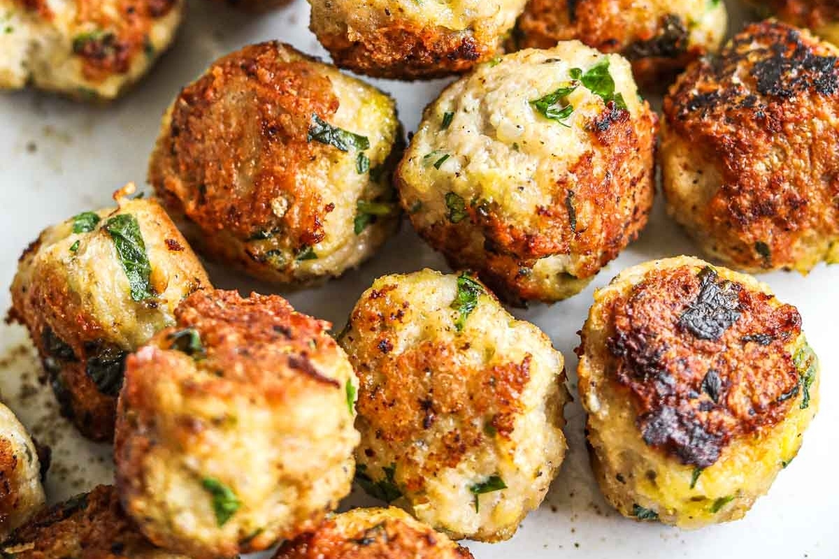 Bite-sized chicken meatballs on a white plate.