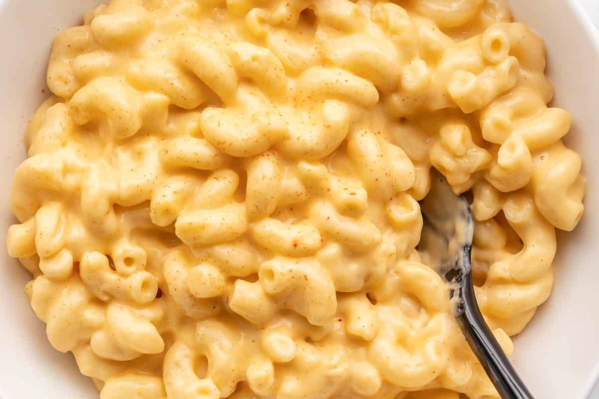 Macaroni and cheese, a delicious side dish, served in a white bowl.