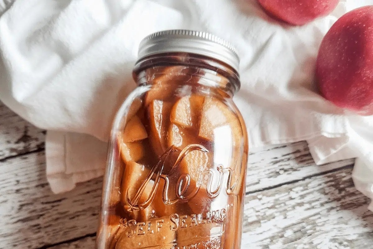 A jar filled with fresh apples, perfect for gifting.