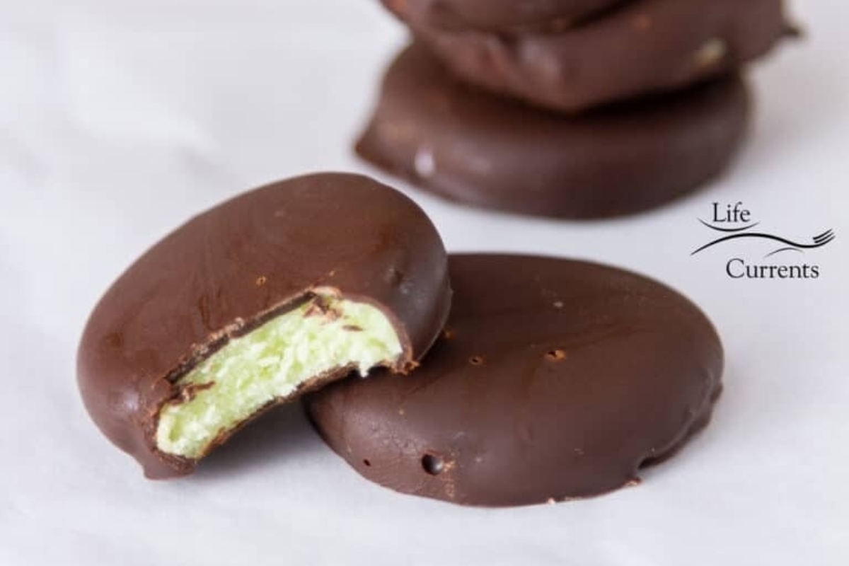 A stack of chocolate cookies with a bite taken out of them, perfect for peppermint lovers.
