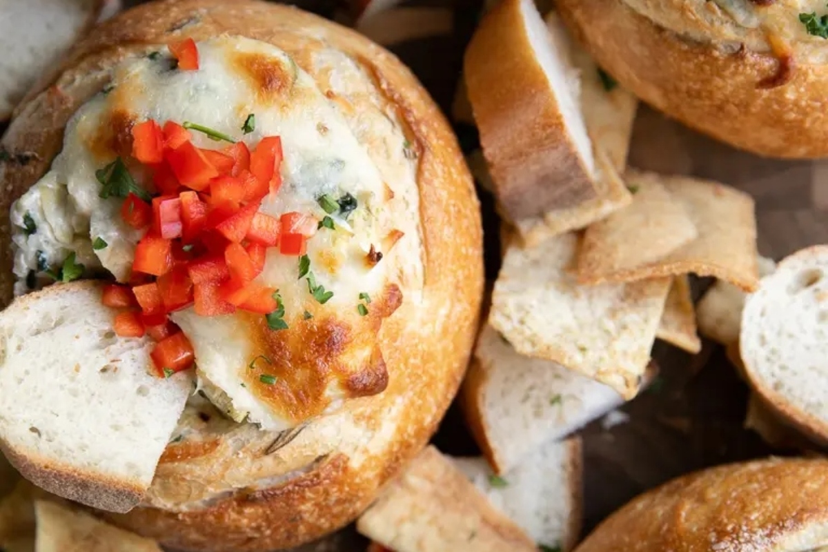 Cheesy bread bowls topped with cheese and peppers, perfect for thanksgiving.