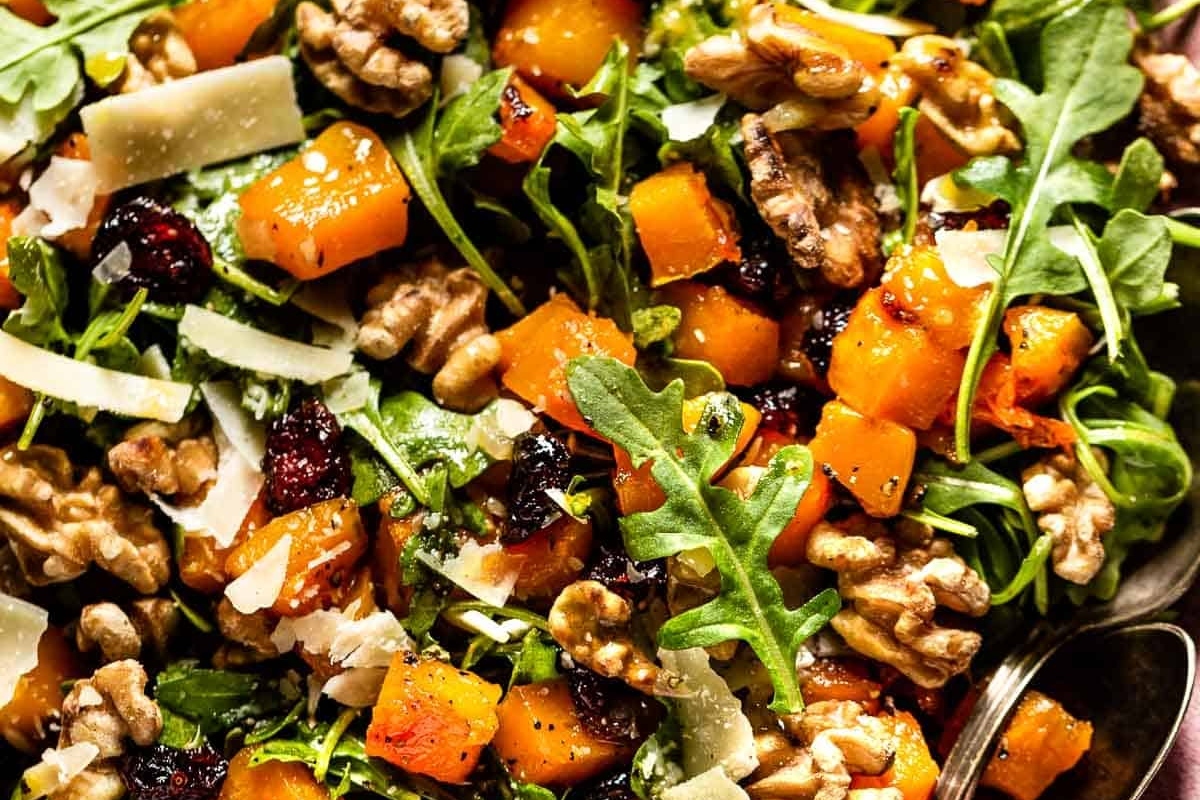A festive Christmas salad with walnuts, cranberries, and arugula.