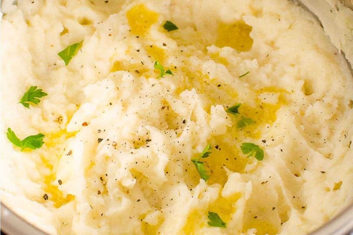 A festive close up of mashed potatoes, a beloved Christmas side dish, cooking in a pot.