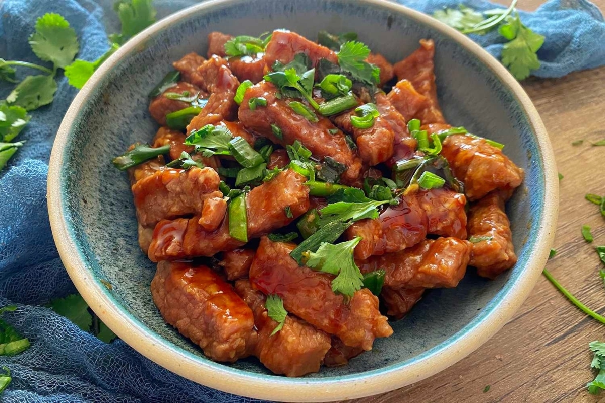 A Delicious bowl of asian meat in a sauce.