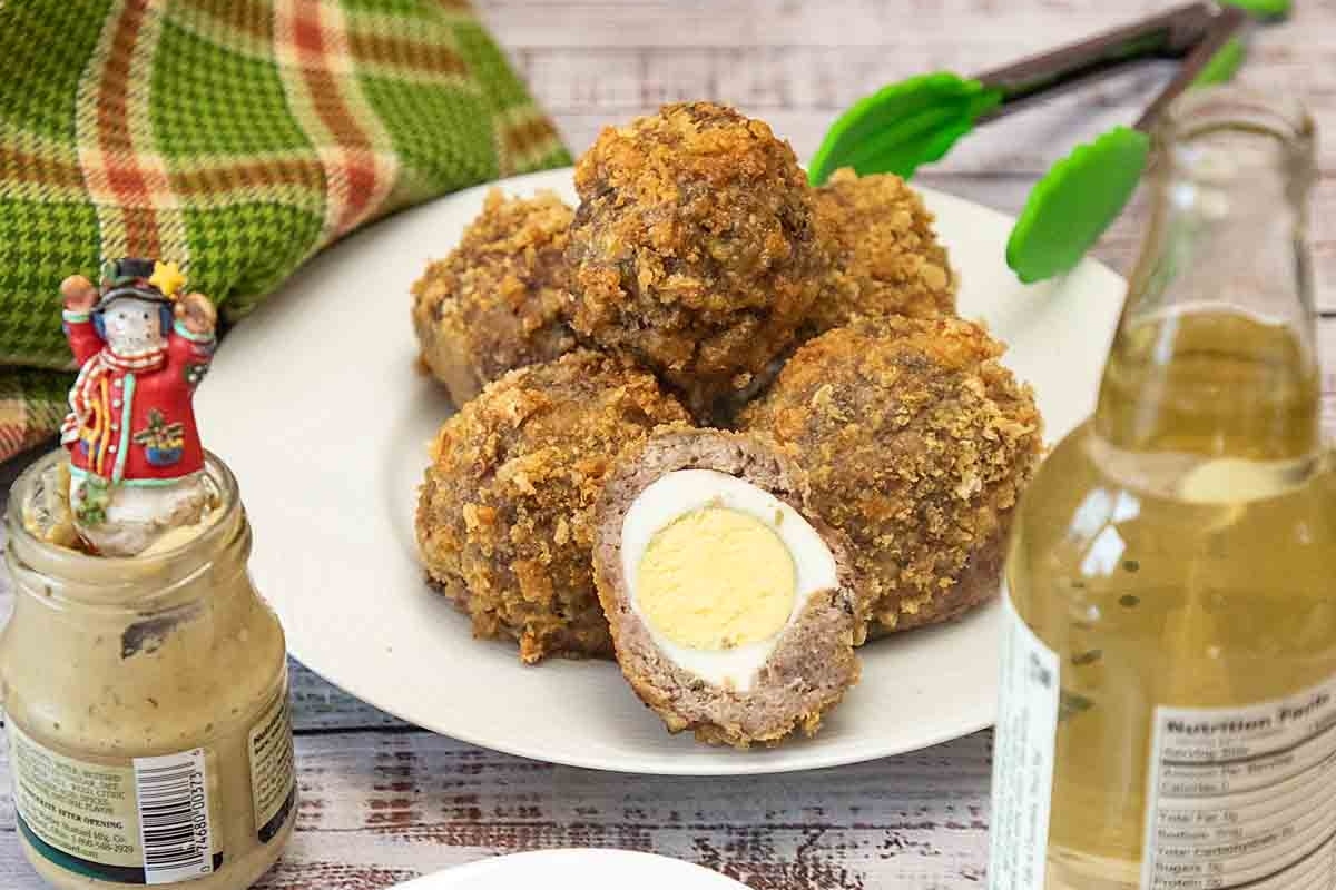 A bite-sized plate with a fried egg and a bottle of beer, perfect for game day.