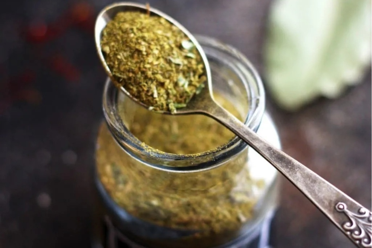 A jar filled with various herbs, displayed gracefully on a table. This makes for a unique and thoughtful gift.