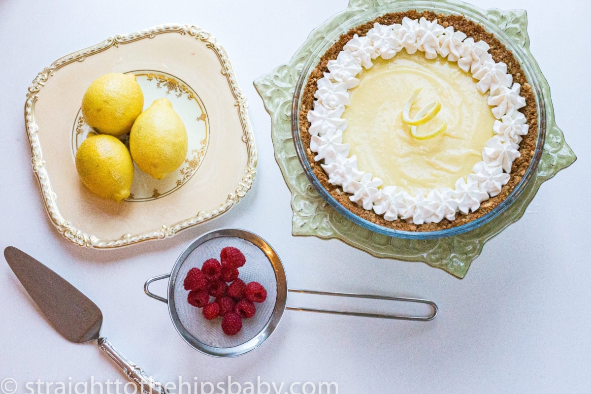 A tangy lemon treat topped with delicate raspberries and fluffy whipped cream.