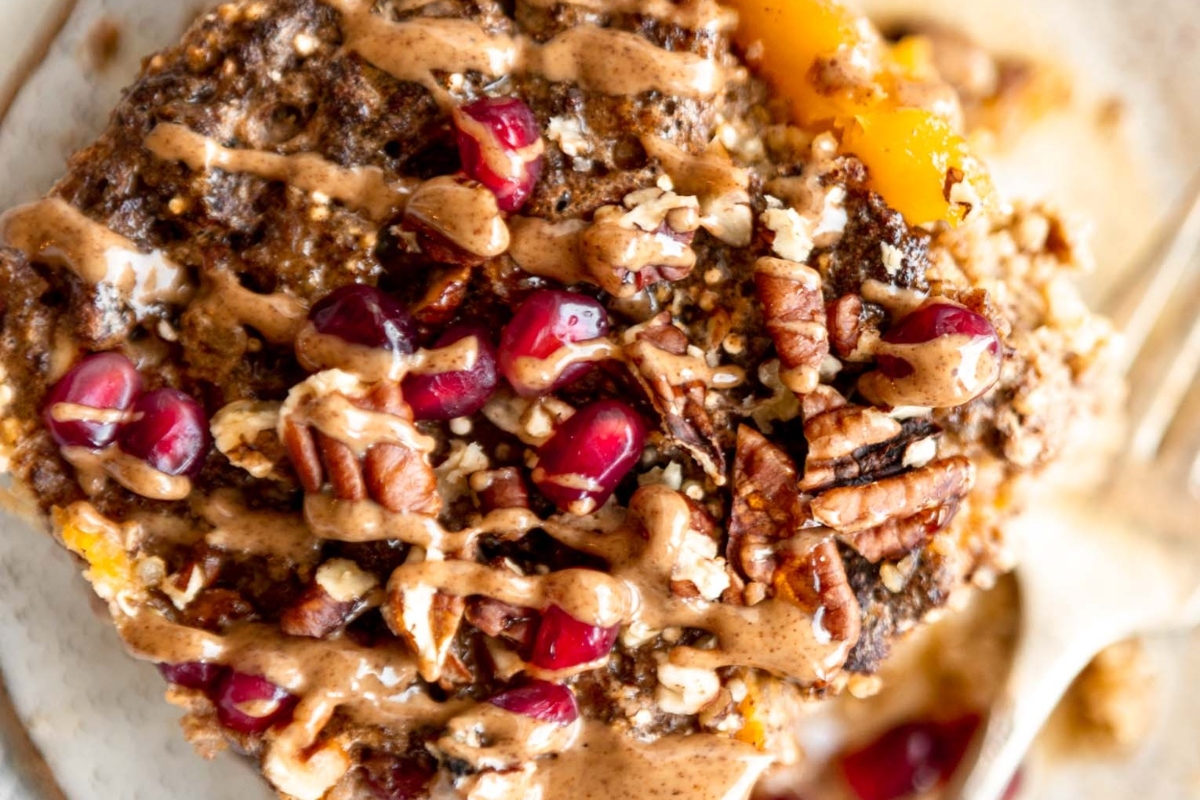 A sweet plate of oatmeal with pomegranate and pecans, perfect for a festive Christmas breakfast.