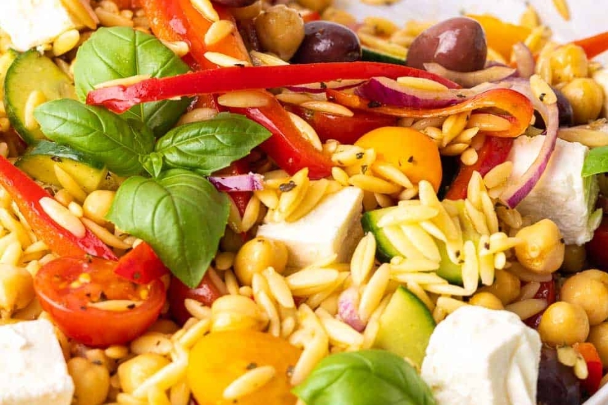 A hearty bowl of Greek salad with chickpeas, tomatoes, and olives.