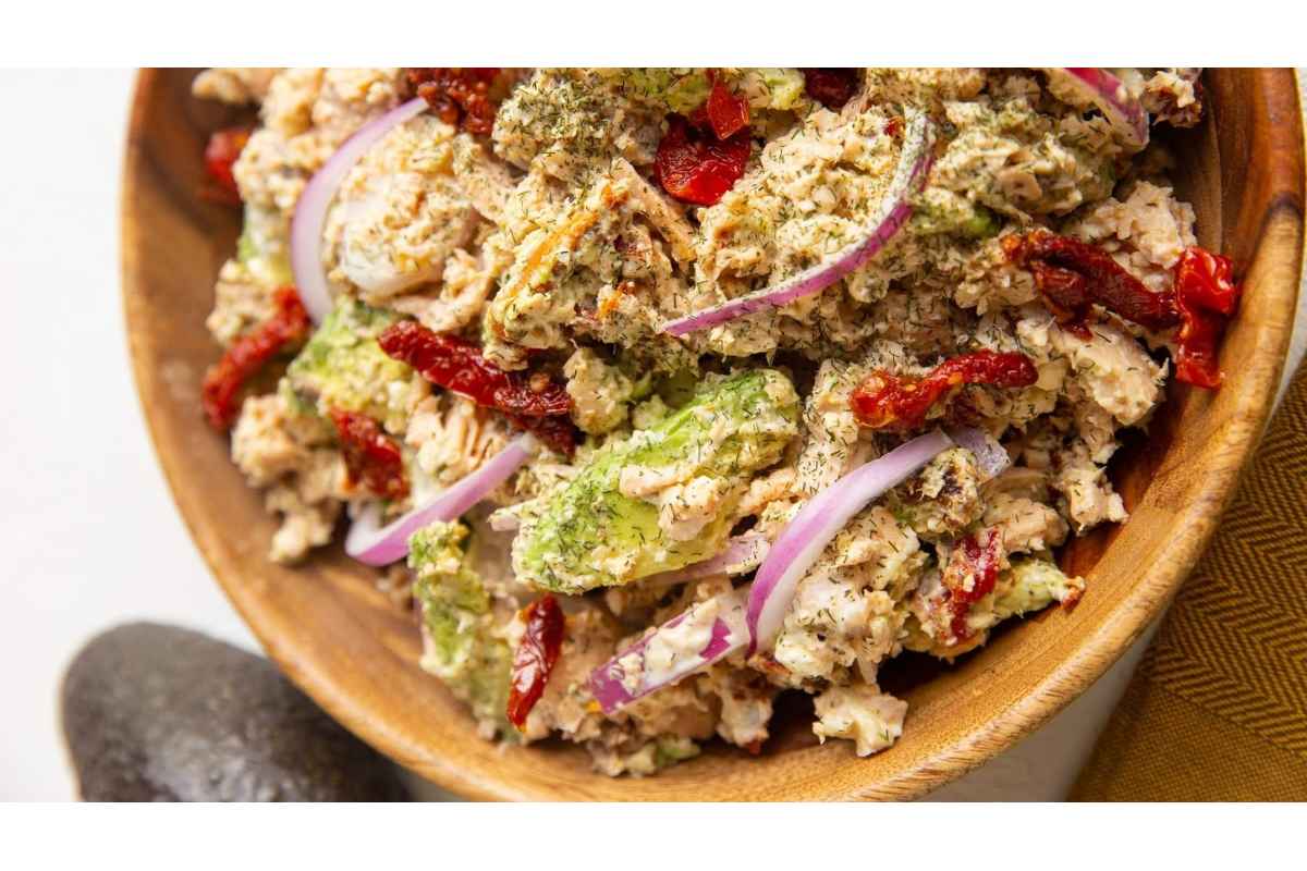 A healthy bowl of tuna salad, high in protein, topped with red onion and avocado. Perfect for lunches.