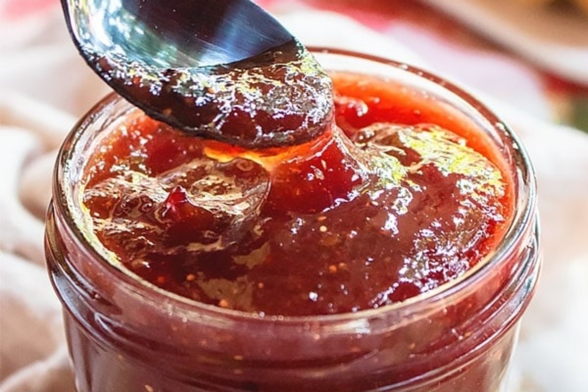 A jar filled with a spoonful of jam, perfect for gifting.