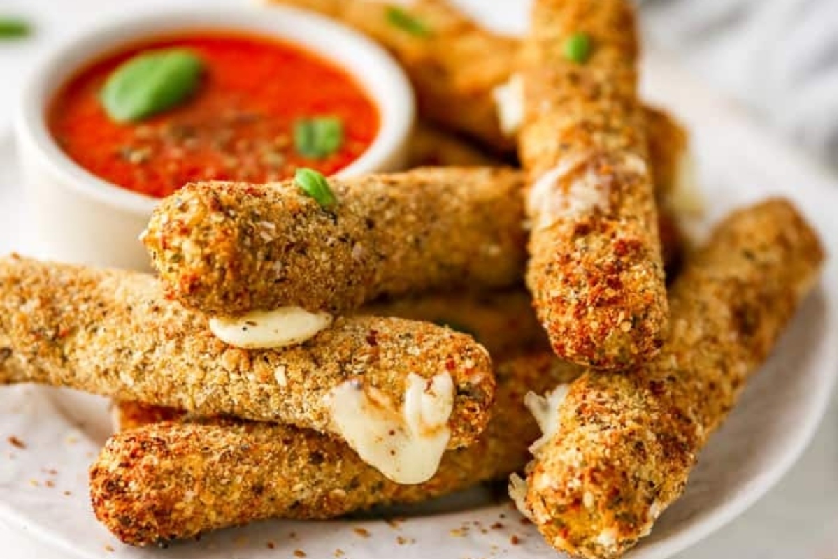 Bite-sized cheesy bread sticks perfect for game day, served with a mouthwatering dipping sauce.
