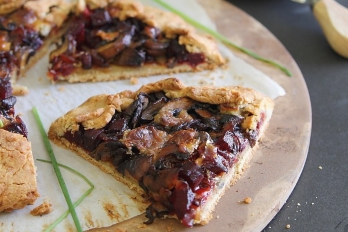 A slice of pie with cranberries and mushrooms, perfect for those who love unique flavors.