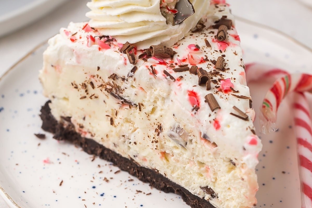 A slice of peppermint cheesecake on a plate. This delectable dessert combines the creamy richness of cheesecake with the refreshing burst of peppermint flavor. Perfect for any occasion, this