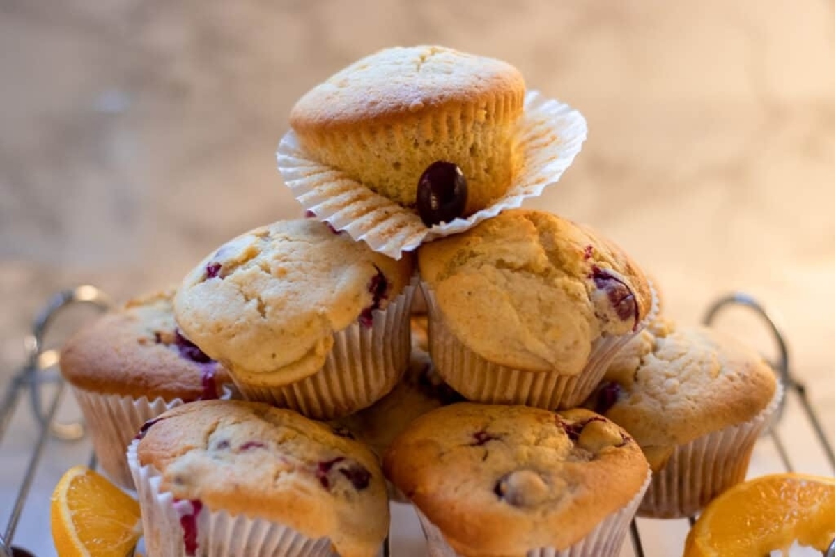 Cranberry orange muffins on a cooling rack, perfect for a snack or breakfast.