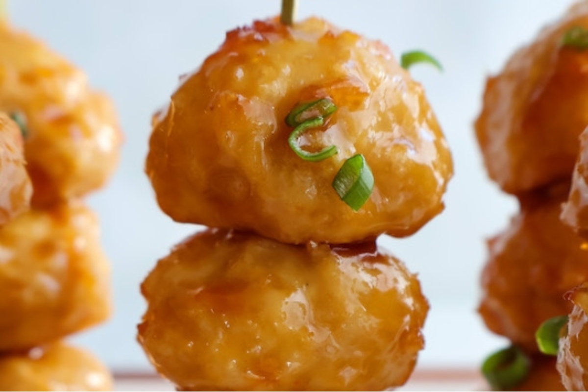 Game Day snack: Bite-sized chicken meatballs on skewers with green onions.