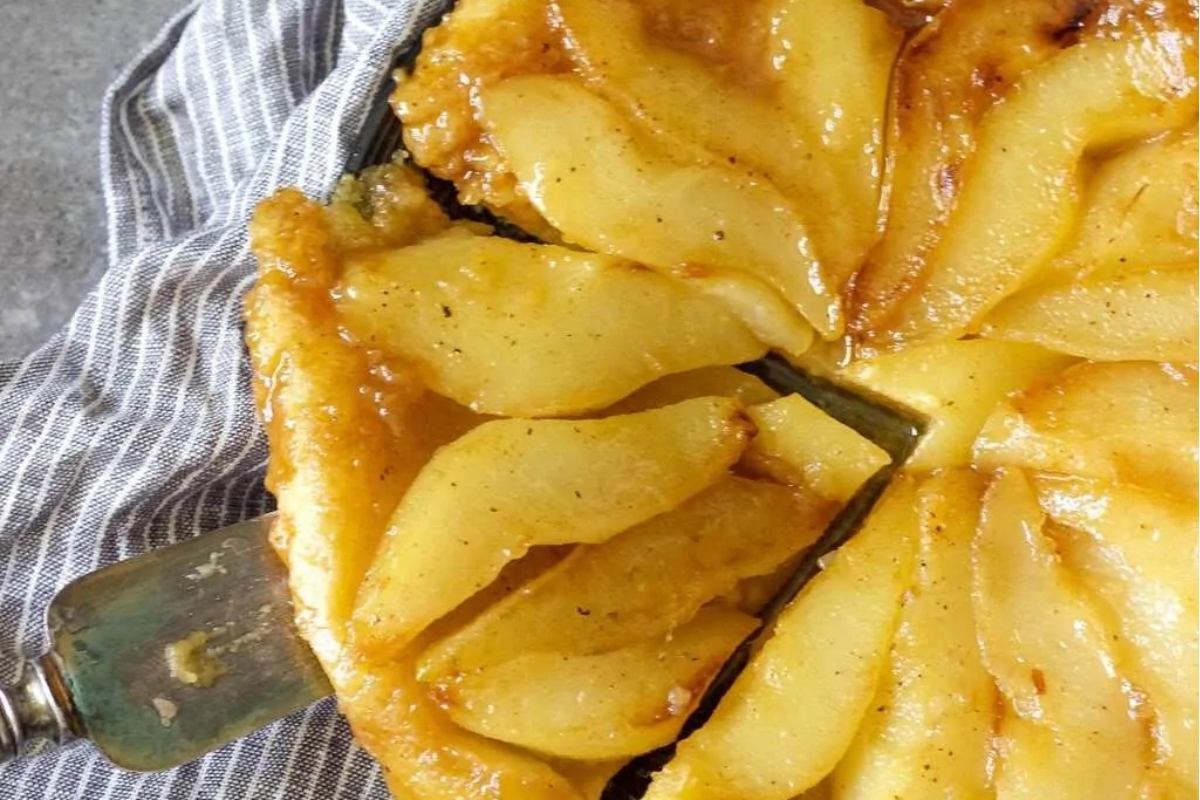 A slice of tart apple pie on a plate with a fork.