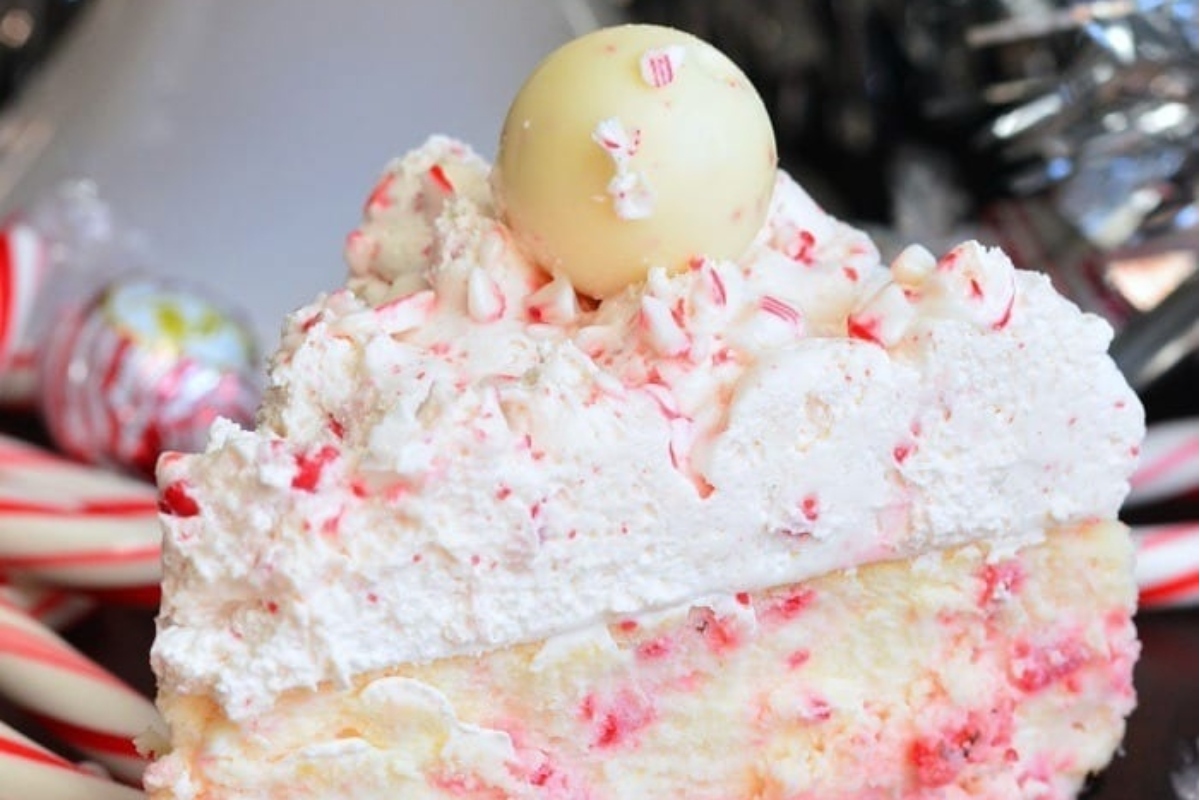 A peppermint-themed dessert featuring a mouthwatering slice of cheesecake served on a plate adorned with festive candy canes.