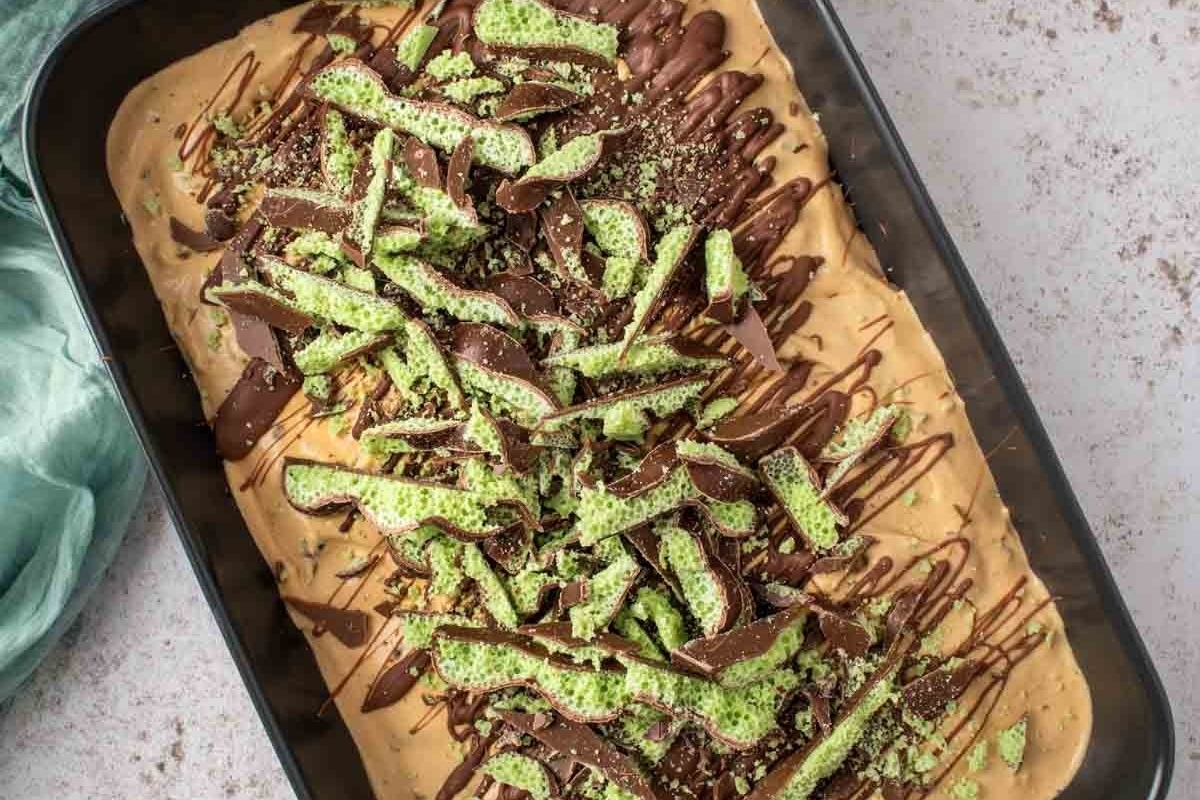 A baking pan with a brownie covered in chocolate and sprinkles, perfect for indulgent recipes.