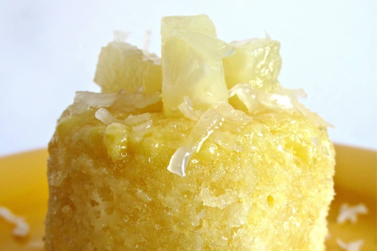 A tropical-inspired yellow cake topped with coconut and pineapple, perfect for mug cake recipes.